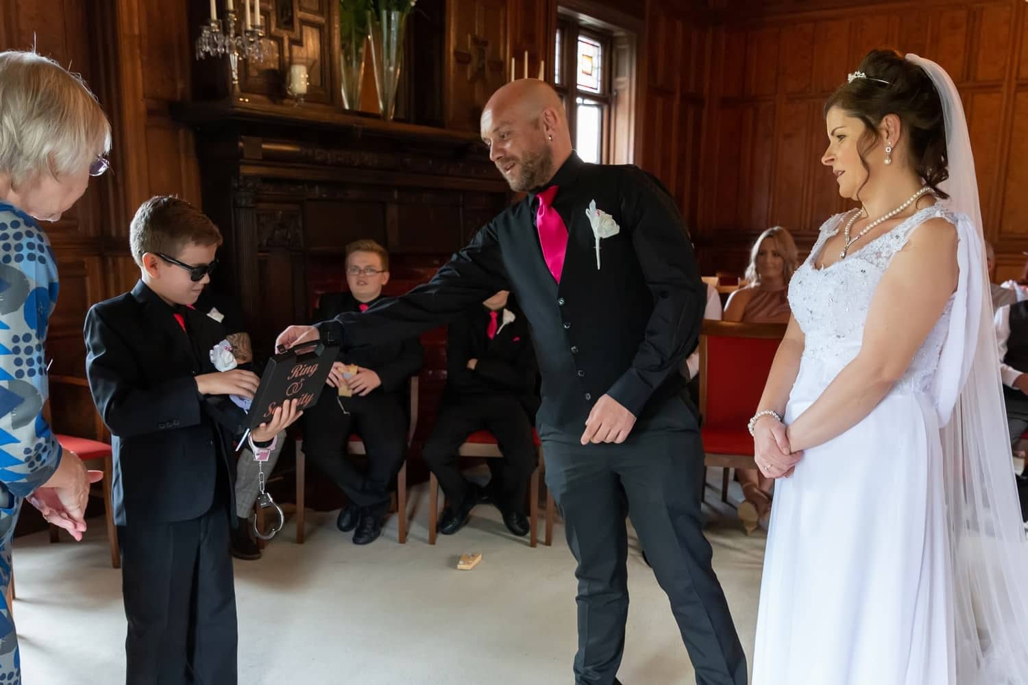 Groom takes a ring from the ring bearer at Carlisle Registry Office