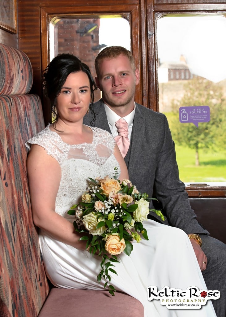 Bride and Groom with Flowers in a railway carriage in Tullie House Carlisle